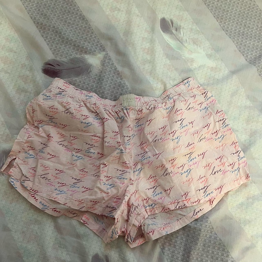 Pink shorts with the designs love across it